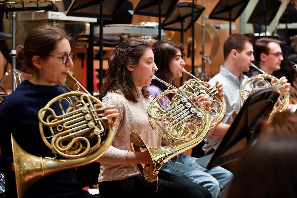 Students playing the french horn in rehearsals in the Amaryllis Fleming Concert Hall